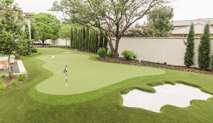 Custom backyard putting green Backyard putting green with a sand trap and multiple holes.