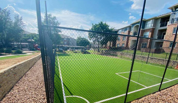 Apartment complex basketball court Basketball court with artificial turf at an apartment complex.