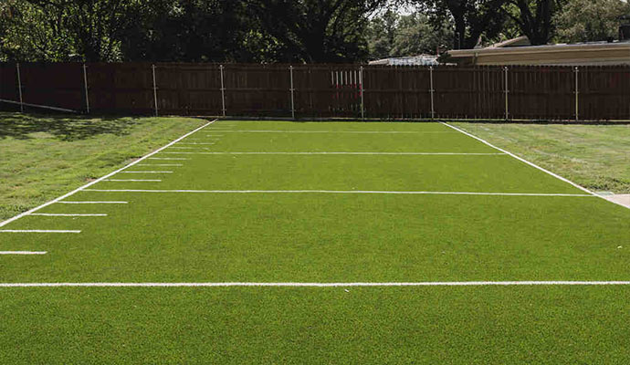 Personal backyard football field Backyard American football field with artificial turf.
