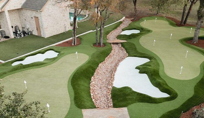 Artificial turf installed around trees for a natural and clean landscape