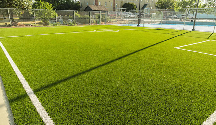 New community futsal court Close-up of a new artificial turf soccer field.