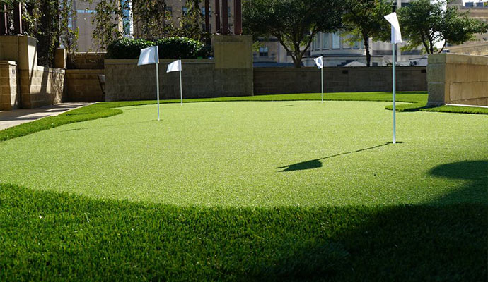 Custom artificial turf putting green Artificial turf putting green in an urban setting.