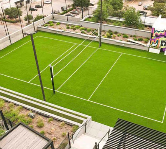 Urban rooftop sports court Rooftop volleyball court with artificial turf at a modern building.