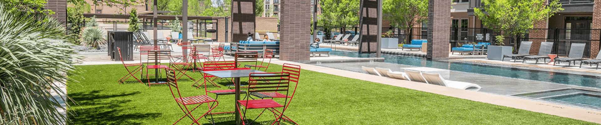 Artificial grass and relaxing chair in pool side.