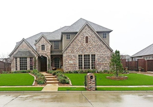 Big and beautiful house surrounded by artificial grass